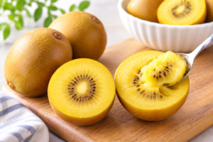 Gold kiwi fruit sliced in half showing golden flesh and seeds