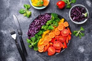 Colorful vegetables including peppers tomatoes carrots and red cabbage